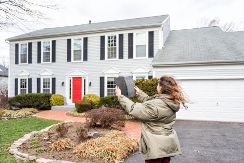 girl holding roofing shingle
