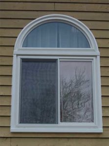 Sliding white window with arched transom
