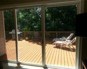 Triple sliding glass door with view of outside deck