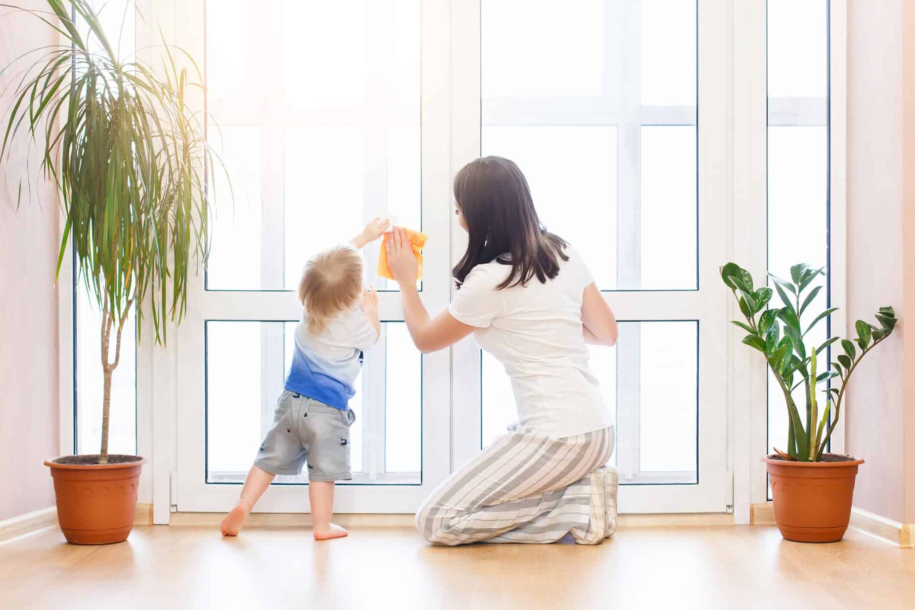 mother and son cleaning windows