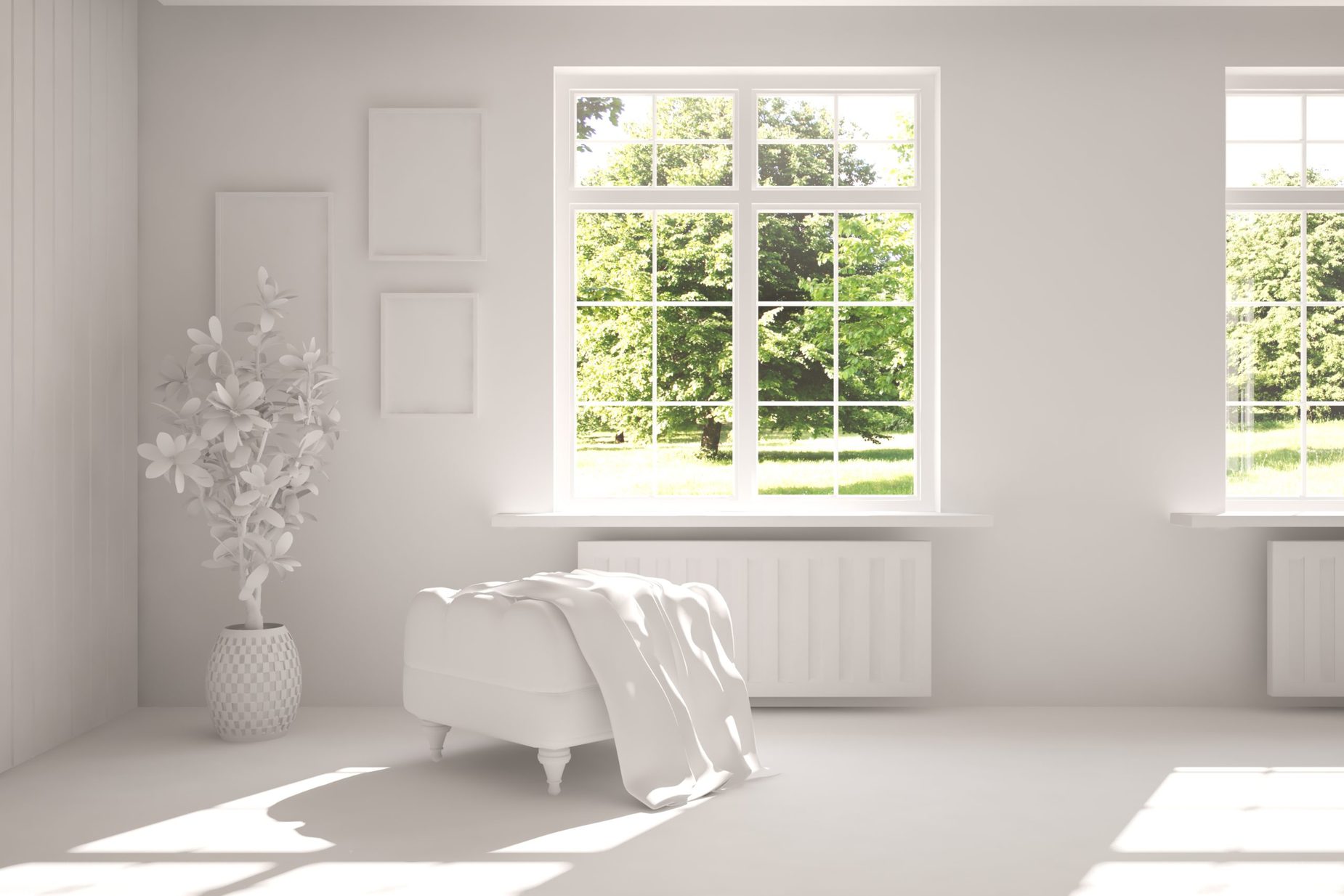 White room with chair and green landscape in window.