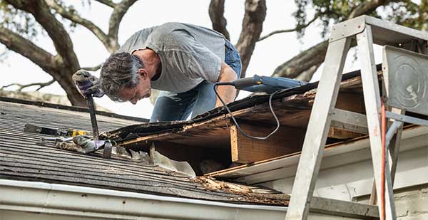 Man fixing leaking roof