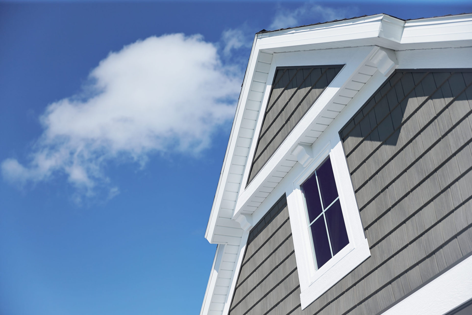 grey siding with sky in background