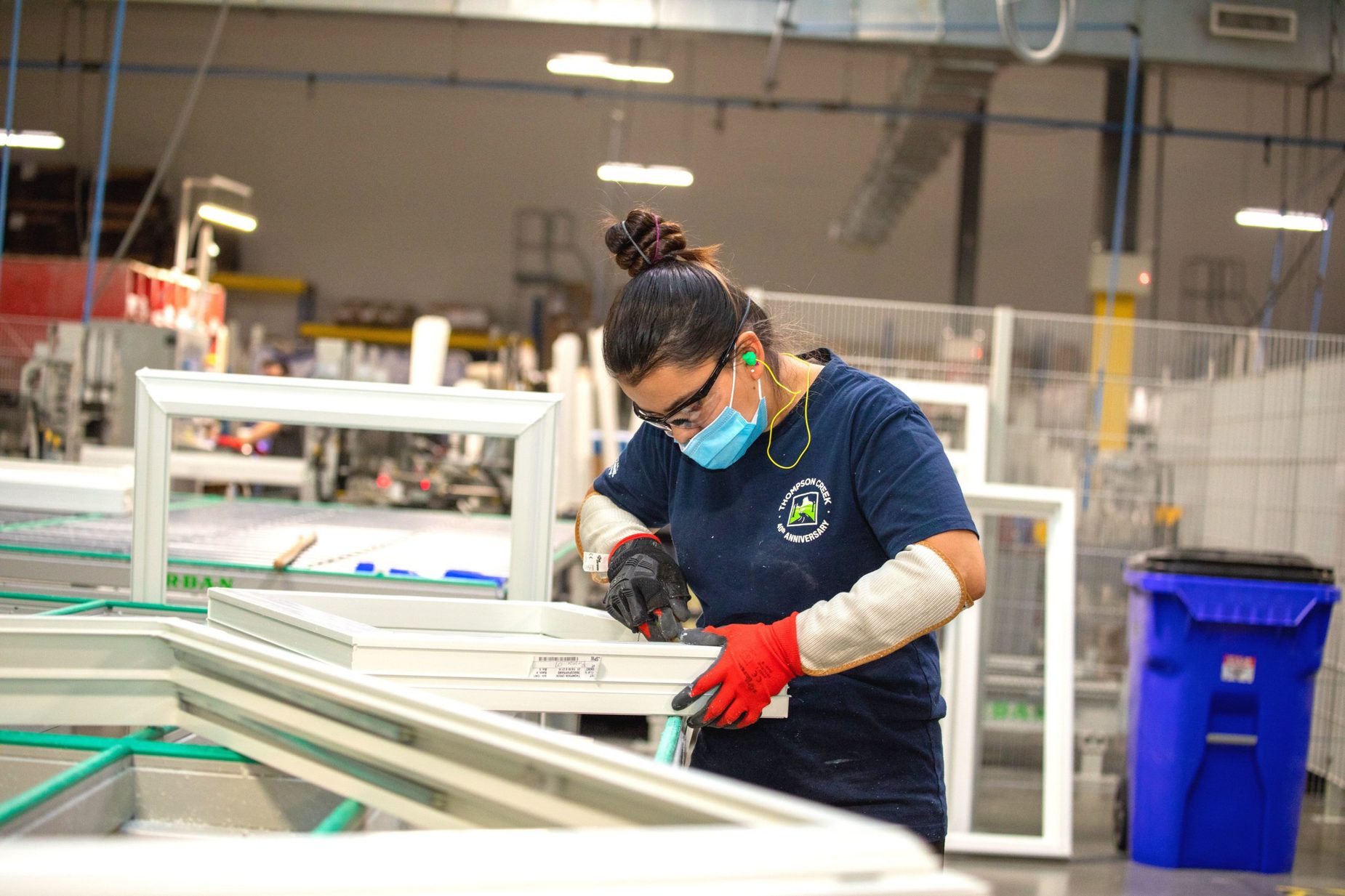 Thompson creek employee working on window in factory
