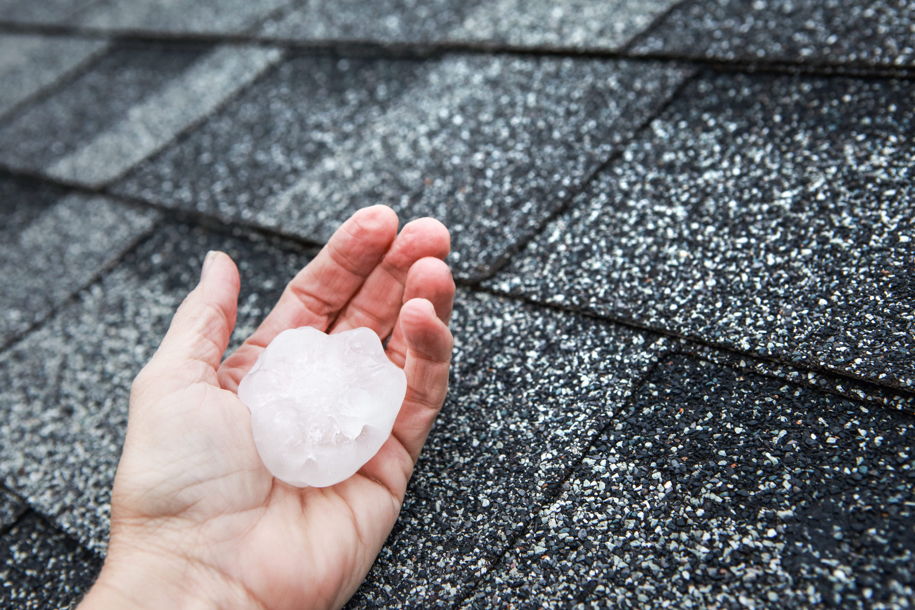 Hail,In,Hand,On,A,Rooftop,After,Hailstorm